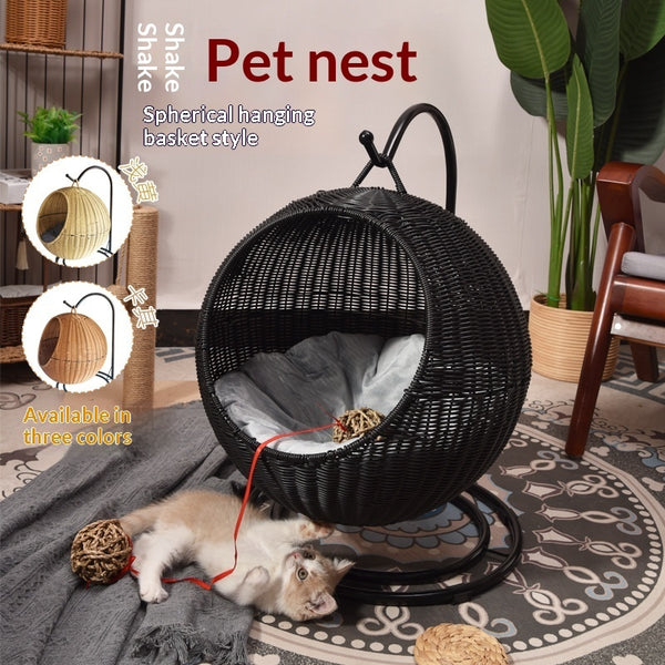 Black spherical hanging pet nest with a cat inside, surrounded by plants and furniture.