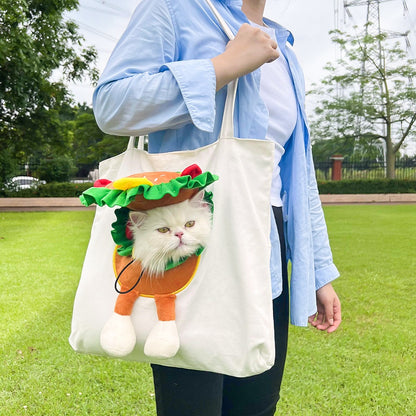 Person holding a tote bag with a cat design of a taco outdoors.