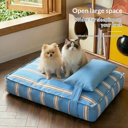 A blue striped pet bed with a matching pillow, shown on a wooden floor in a room with a dog and cat sitting on it. White text in the upper right reads 'Open large space Wider for sleeping on your back'.