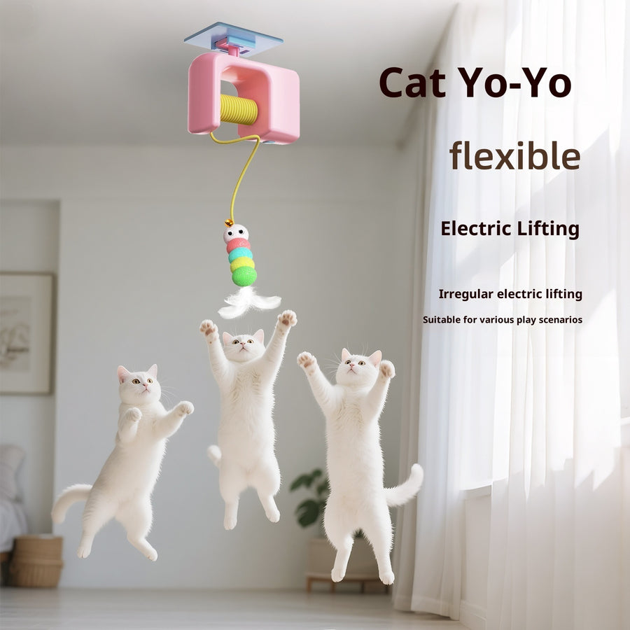 Cat toy with electric lifting mechanism and three white cats playing with it in a room.