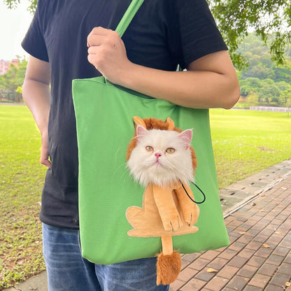 Person holding a green tote bag with a cat design outdoors.