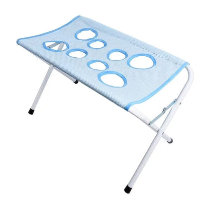 Portable folding stool with blue mesh seat on a white background