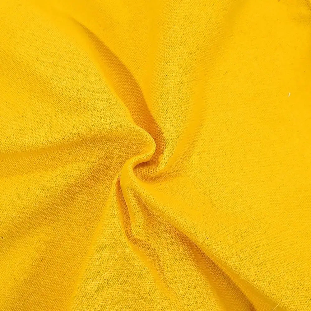 A close-up of bright yellow fabric with a visible woven texture and soft folds gathered toward the center.