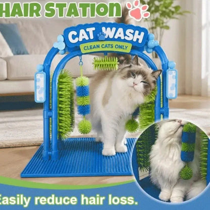A cat grooming brush playpen with a blue arch frame, green and blue brush rollers, and a white cat standing inside. The image includes marketing text 'HAIR STATION' and 'CAT WASH' and a circular inset showing a close-up of the cat using the brush.