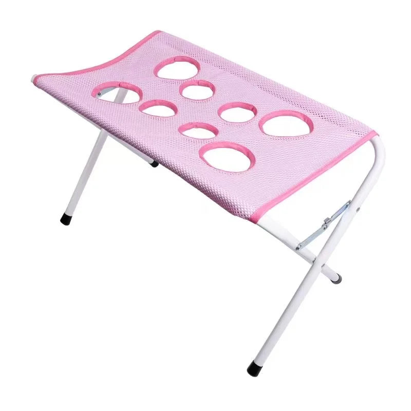 Pink mesh stool with multiple holes on a white background