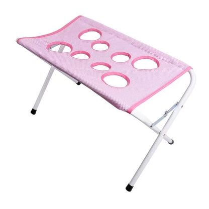Pink mesh stool with multiple holes on a white background