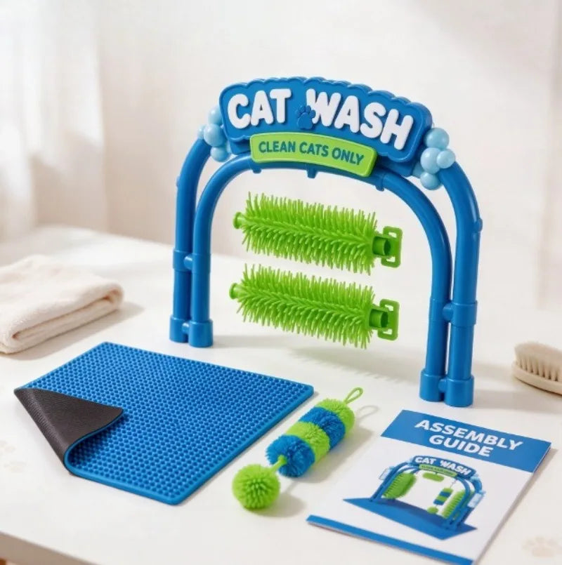 Blue and green cat wash brush set with a cleaning mat, brush, toy, and assembly guide on a white tabletop.