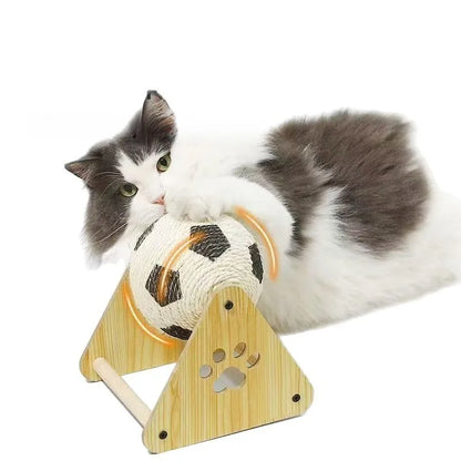 Cat playing with a wooden toy resembling a soccer ball on a white background
