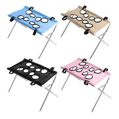 Four portable folding camp stools with integrated cup holders, shown in blue, beige, black, and pink fabric options on a white background.
