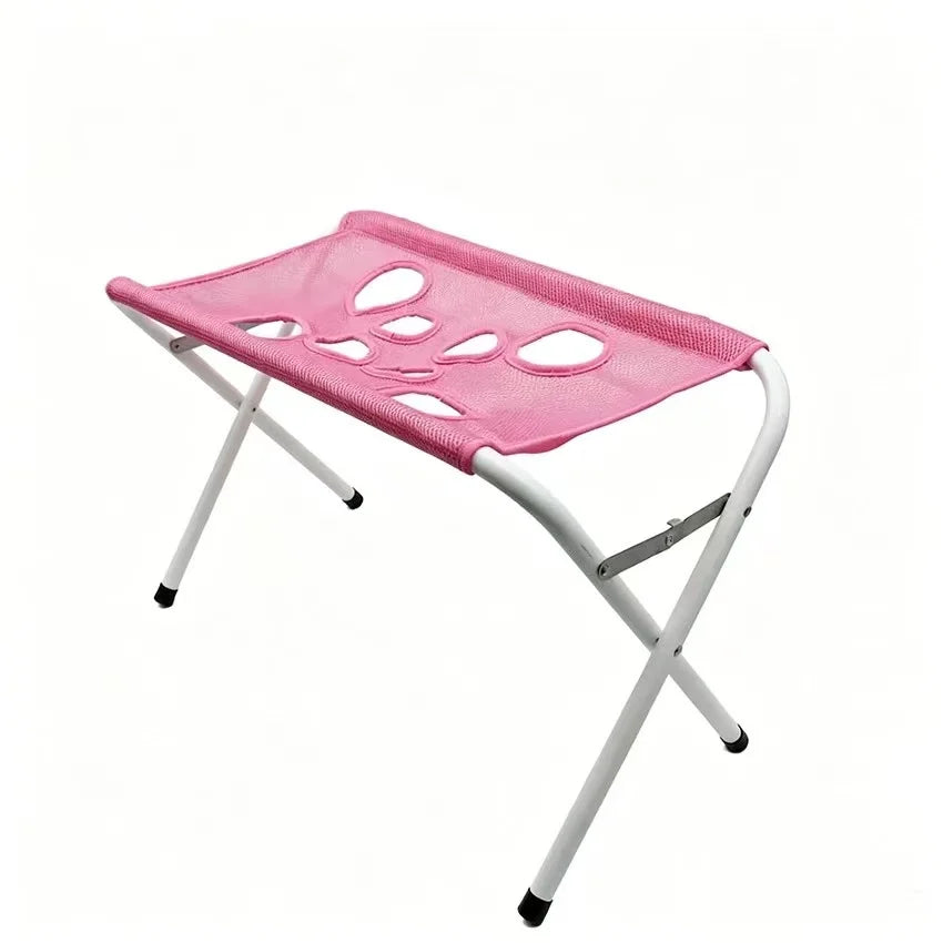 A pink mesh folding stool with a white metal frame and black rubber feet, shown on a plain white background.