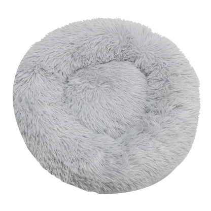 Round, fluffy gray pet bed on a white background