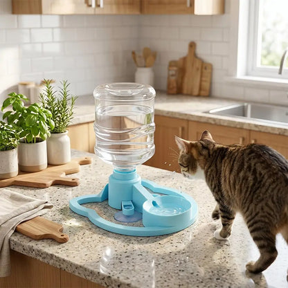 Cat drinking water from a blue and clear pet water fountain on a kitchen counter.