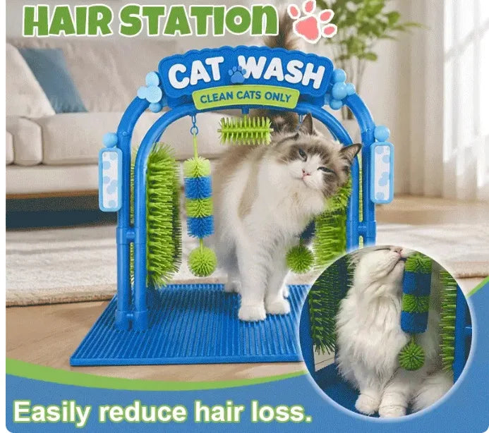 A cat grooming brush stand labeled 'CAT WASH' with a fluffy white and gray cat standing on it in a living room setting. The stand is blue with green and blue brush attachments, and the image includes marketing text and a circular inset showing the cat using the grooming brush.