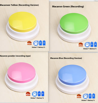 Four pet sound button toys shown in a 2x2 grid, labeled for different recording versions: Macaron Yellow, Macaron Green, Macaron powder (recording type), and Macaron Blue. Each toy has a round glossy colored top on a white circular base, with small icons indicating included stickers and batteries.