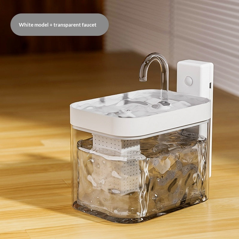 Portable sink with white basin and transparent faucet on a wooden surface