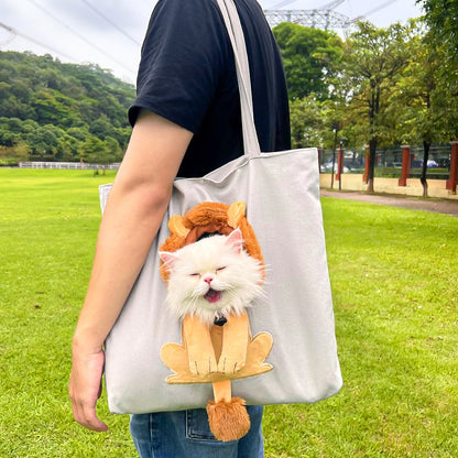 Person holding a tote bag with a cat design in a park